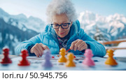 Senior Moment: Elderly woman enjoys a board game outdoors against mountain backdrop. Стоковое AI-изображение, AI-художник Данила Большаков / Фотобанк Лори