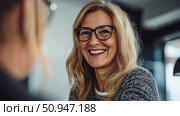 Friendly professional: portrait of a smiling woman during a business discussion. Стоковое AI-изображение, AI-художник Данила Большаков / Фотобанк Лори