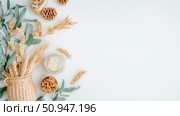 Autumn harvest concept: wheat ears, nuts and cone for Thanksgiving day, flatlay template. Стоковое AI-изображение, AI-художник Данила Большаков / Фотобанк Лори
