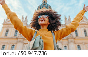 Joyful Woman Embracing Life in Cityscape with Uplifted Arms and Architectural Landmark, for travel and lifestyle content. Стоковое AI-изображение, AI-художник Данила Большаков / Фотобанк Лори