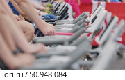 Athletes Competing on Stationary Bikes at Sports Event. Стоковое видео, видеограф Mikhail Davidovich / Фотобанк Лори