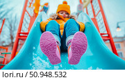 Childhood fun on a playground slide on a winter day. Стоковое AI-изображение, AI-художник Данила Большаков / Фотобанк Лори