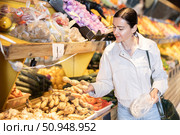 Female shopper selects ginger root in supermarket. Стоковое фото, фотограф Яков Филимонов / Фотобанк Лори