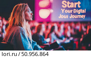 Young woman attentive at a digital transformation conference, ready to embark on her innovation journey, suitable for business event promotion. Стоковое AI-изображение, AI-художник Данила Большаков / Фотобанк Лори