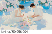 Romantic outdoor gathering: A sun-drenched painting of a couple sharing a delightful meal surrounded by beautiful blossoms, perfect for an art print or celebratory card. Стоковое AI-изображение, AI-художник Данила Большаков / Фотобанк Лори