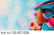 Vibrant academic cap with an orange tassel against a soft blue bokeh backdrop, representing educational achievement and bright futures, perfect for graduation season greetings or promotional banners. Стоковое AI-изображение, AI-художник Данила Большаков / Фотобанк Лори