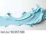 A vibrant ribbon of bright blue paint elegantly swirls in mid-air, creating an abstract art piece. The dynamic motion and fluid form contrast against the stark white background, emphasizing its vividness. Стоковое AI-изображение, AI-художник Nart / Фотобанк Лори