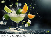A deconstructed margarita with mid-air lime wedges and a salted rim captures the art of mixology. This visually striking cocktail includes tequila, triple sec, and suspended crushed ice. Стоковое AI-изображение, AI-художник Nart / Фотобанк Лори