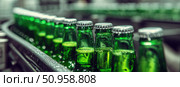 Beer Bottling plant. Green Beer Bottles in rows. Bottling process in modern factory. Capped Glass Beer Bottles ready for distribution in a brewery. Manufacturing. Production of beer in a glass bottle. Стоковое AI-изображение, AI-художник Марина Демидюк / Фотобанк Лори