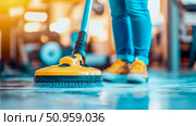 Dynamic close-up of a person diligently operating a bright yellow floor cleaning machine, effectively scrubbing for meticulous hygiene and pristine floor surfaces. Стоковое AI-изображение, AI-художник Данила Большаков / Фотобанк Лори