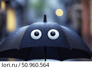 Close-up of black umbrella with cartoon eyes in rainy weather. Стоковое AI-изображение, AI-художник Катерина Бондарец / Фотобанк Лори