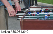 Hands Engaging in Intense Foosball Match Outdoors. Стоковое видео, видеограф Mikhail Davidovich / Фотобанк Лори
