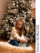 Christmas Dreams a Little Girl Makes With Her Surprise Gift at Home. Стоковое фото, фотограф Aleksandr Golubev / Фотобанк Лори