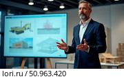General manager of major construction company gives keynote presentation in sleek office space. Стоковое AI-изображение, AI-художник Сергей Бирюков / Фотобанк Лори
