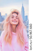 A vibrant young woman with flowing pink blonde hair smiles widely outdoors, capturing a moment of genuine happiness and urban charm against a bright cityscape. Стоковое AI-изображение, AI-художник Данила Большаков / Фотобанк Лори