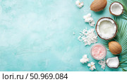 Tropical natural beauty and spa essentials with fresh coconuts, creamy oil, shredded flakes, and exotic flowers on a vibrant blue textured background, perfect for skincare and wellness concepts. Стоковое AI-изображение, AI-художник Данила Большаков / Фотобанк Лори