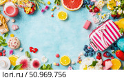 A bountiful and colorful overhead display of summer-themed fruits, sweets, and playful items on a textured blue background, perfect for a joyful occasion. Стоковое AI-изображение, AI-художник Данила Большаков / Фотобанк Лори