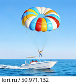 Man Para sailing Behind a Boat on a Sunny Day. Generative AI. Стоковое AI-изображение, AI-художник Roman Zavorotny / Фотобанк Лори