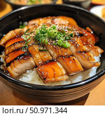 An appetizing Japanese dish — fried pork in teriyaki glaze, sliced and laid on top of hot rice in a deep black bowl. The dish is garnished with sesame seeds and fresh green onions. Ideal for illustrating restaurant menus, food delivery, culinary blogs and thematic publications about Japanese food. Стоковое AI-изображение, AI-художник Анна Кривицкая / Фотобанк Лори