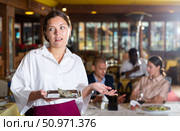 Woman waiter demonstrating her upset with small tip. Стоковое фото, фотограф Яков Филимонов / Фотобанк Лори