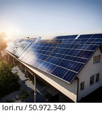 Solar panel on the roof of a house, both energy and ecology. Стоковое AI-изображение, AI-художник lyudmila Soloveva / Фотобанк Лори