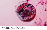 Elegant wine goblet in motion, burgundy liquid cascading with effervescence against a monochrome rose setting, delicate floral accents on the perimeter. Стоковое AI-видео, аниматор Данила Большаков / Фотобанк Лори