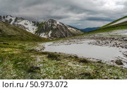 Natural rock formation on a green valley and snow riwer. Стоковое фото, фотограф Саблин Станислав / Фотобанк Лори