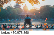 Alone individual in a mobility chair peacefully observes a tranquil lake adorned with swimming waterfowl and distant Asian structures bathed in golden light. Стоковое AI-видео, аниматор Данила Большаков / Фотобанк Лори