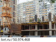 Cтроительство многоэтажного здания. Конструкция крана с нижним противовесом. Стоковое фото, фотограф Эдуард Белкин / Фотобанк Лори