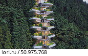 Innovative green building nestled in a forest, demonstrating harmony between modern architecture and environment, promoting sustainable living and eco conscious design. Стоковое AI-видео, аниматор Данил Руденко / Фотобанк Лори