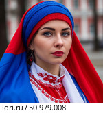 Девушка в русском национальном костюме и в платке с цветами российского флага. Стоковое AI-изображение, AI-художник Юлия Усач / Фотобанк Лори