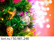 Christmas tree toys on a festive tree, glisten in the light of lights. Стоковое фото, фотограф Коханова Наталья / Фотобанк Лори