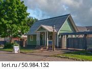 Izborsk, Pskov region, Russia, June 9, 2024: View of historical merchant buildings of estates on the main street of Izborsk Pechorskaya Street on a summer sunny day. Редакционное фото, фотограф Ula Ulachka / Фотобанк Лори