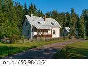 View of residential buildings on the territory of the Mikhailovskoye estate of the Pushkin State Museum-Reserve on a sunny summer day, Pushkinskiye Gory, Pskov region, Russia. Стоковое фото, фотограф Ula Ulachka / Фотобанк Лори