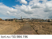 View of the fortress city of Saint-Malo on the English Channel and the ocean floor exposed at low tide on a sunny summer day, Brittany, France. Стоковое фото, фотограф Ula Ulachka / Фотобанк Лори