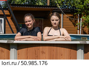 Two teenage sisters swimming in the pool. Стоковое фото, фотограф Андрей Аркуша / Фотобанк Лори