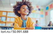 Joyful Child in Classroom: A Portrait of Hope and Education. Стоковое AI-изображение, AI-художник Данила Большаков / Фотобанк Лори