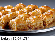 Delicious baklava pieces with nuts filling resting on silver tray. Стоковое фото, фотограф Юрий Поздников / Фотобанк Лори