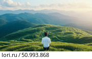 Man Contemplating Serene Mountain Landscape at Sunset: A breathtaking view of rolling green hills and distant mountains, bathed in the golden light of the setting sun, with a lone figure standing in quiet contemplation. Стоковое AI-изображение, AI-художник Данила Большаков / Фотобанк Лори