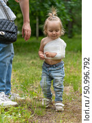 Concern and Care: A Toddler with an Arm Sling, Supported by an Adult, Healing Process, and Parental Care. Стоковое фото, фотограф Данила Большаков / Фотобанк Лори