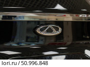 Vitebsk, Belarus - January 2, 2025: Detailed close-up of a vehicle's chrome emblem on a dark surface. Редакционное фото, фотограф Данила Большаков / Фотобанк Лори
