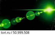 Cinematic lens flare overlay with green light on black background, abstract anamorphic beam with old film texture for video editing and special effect. Стоковое фото, фотограф Павел Муравьев / Фотобанк Лори