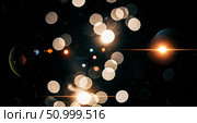 Abstract bokeh overlay with orange lens flare on black background, vintage light effect with old film texture for cinematic montage or retro wallpaper. Стоковое фото, фотограф Павел Муравьев / Фотобанк Лори