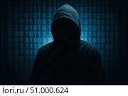 Hacker. A Mysterious Figure in a Hoodie Stands Silently Against a Background of Glowing Binary Code, Representing the Intrigue of Cybersecurity and Digital Anonymity. Стоковое AI-изображение, AI-художник Башкирова Анна / Фотобанк Лори