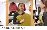 Man with wife participate in inspection of goods, help determine choice of blouse. Стоковое видео, видеограф Яков Филимонов / Фотобанк Лори