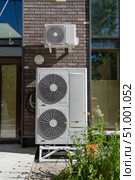 Air conditioning system assembled on side of building. External cooling system units unit compressor install outside. Condensing unit for removing heat and moisture from indoor. Стоковое фото, фотограф Данила Большаков / Фотобанк Лори
