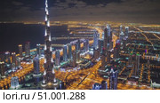 Nighttime aerial panorama revealing Dubai's luminous skyline, glowing Burj Khalifa towering over radiant urban landscape, capturing architectural magnificence and metropolitan brilliance. Стоковое AI-видео, аниматор Данил Руденко / Фотобанк Лори