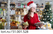 Happy teenage girl choosing and buying different candies and sweets for Christmas celebration. Стоковое видео, видеограф Яков Филимонов / Фотобанк Лори