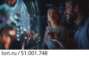Professional analysts discuss data trends at a modern workstation in an advanced tech environment. Стоковое AI-видео, аниматор Сергей Толмачёв / Фотобанк Лори