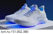 White running shoes with led lights on display. Стоковое AI-видео, аниматор Юрий Поздников / Фотобанк Лори